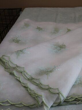 Sheer embroidered 112 x 114" tablecloth.
